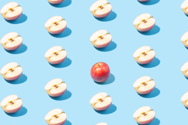 istock Creative summer background of apple halves on a blue background. Minimal summer concept. 1420112590