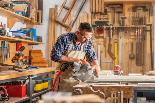istock Mature man cutting wood in workshop 1420112881