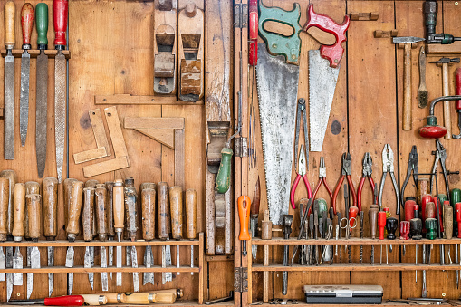 Different types of work tools arranged in workshop.