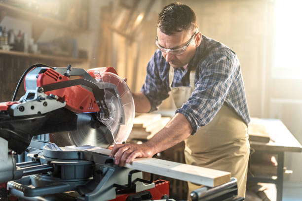 istock Mature man cutting wood in workshop 1420113048