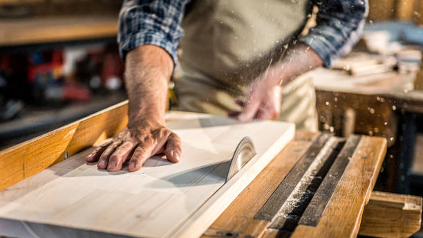 istock Mature man cutting wood in workshop 1420113085