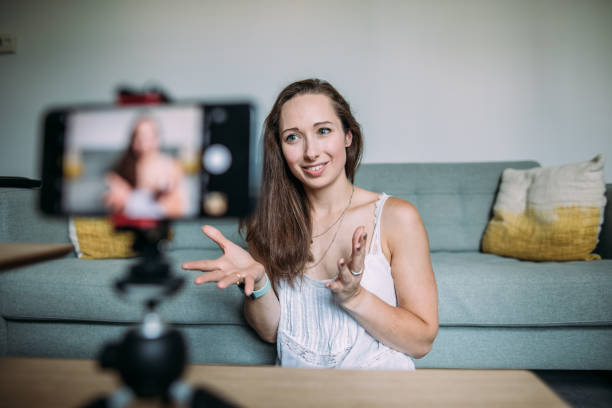 istock Beautiful woman vlogging at home 1420115307