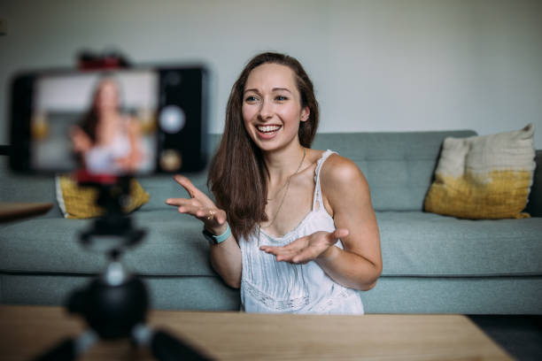 istock Beautiful woman vlogging at home 1420115373