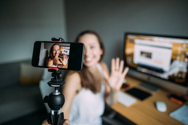 beautiful woman vlogging at home - influencer stockfoto's en -beelden