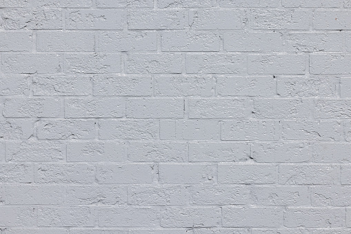 Close-up on an old painted brick wall.