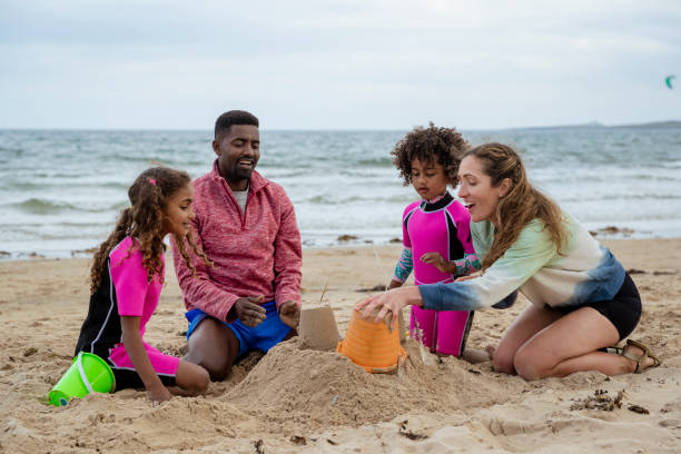 istock Cheerful Family Sand Castle Making 1420117312