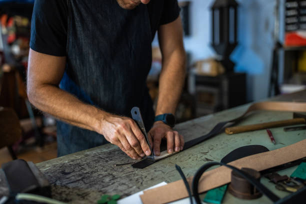 istock Adult man working with leather in workshop 1420118057