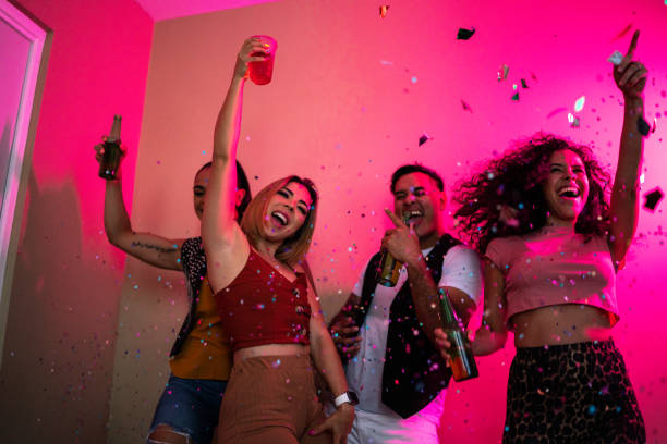 istock Friends celebrating while drinking beer at a party 1420118799
