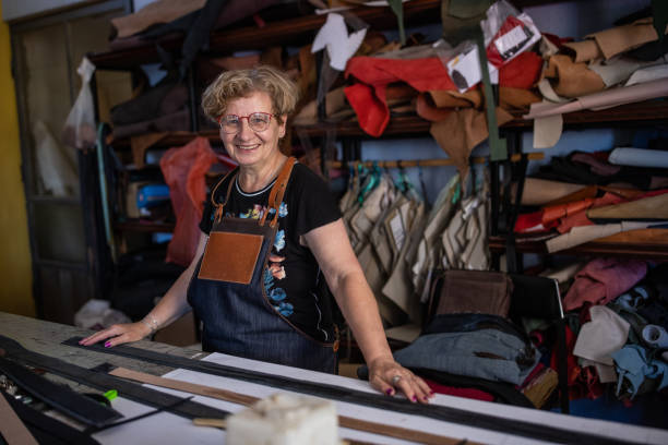 istock Smiling senior woman in a leather workshop 1420119508