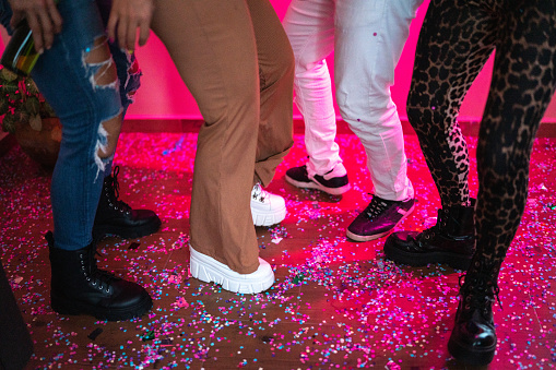 Friends dancing at a party - view of the legs