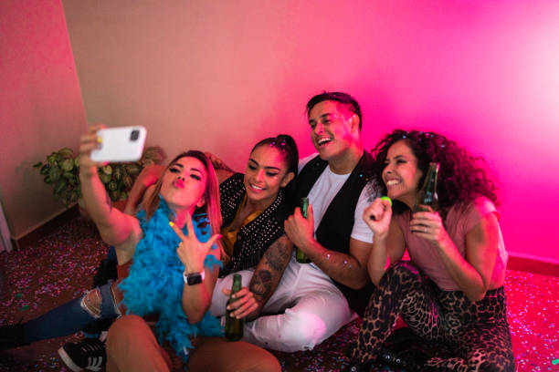 istock Friends taking a selfie using mobile phone at party 1420122091