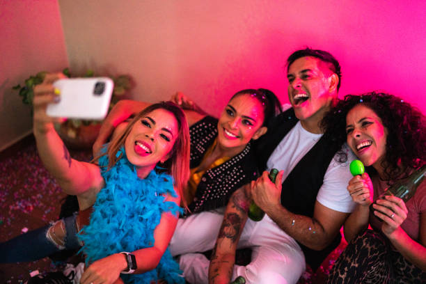 istock Friends taking a selfie using mobile phone at party 1420122103