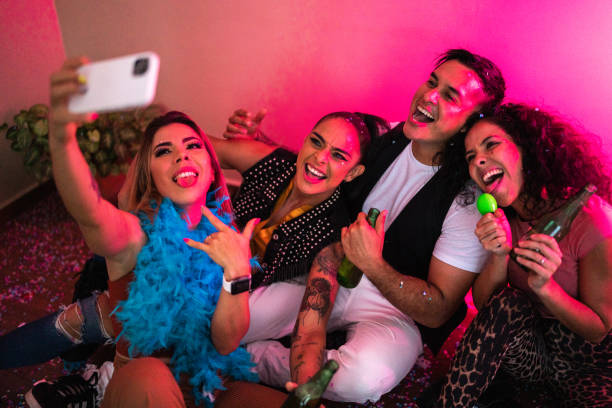 istock Friends taking a selfie using mobile phone at party 1420122108