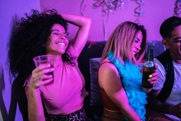 istock Drunk friends having fun while drinking beer at a party 1420123590