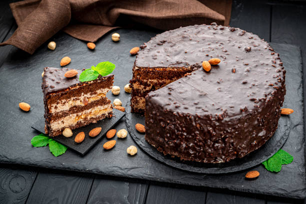 istock Delicious caramel chocolate tart, topped with nuts and hazelnuts, almonds 1420123797