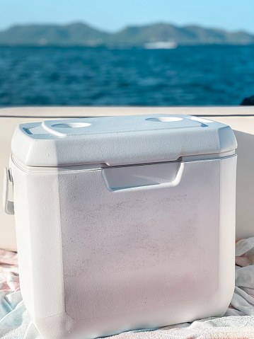 White portable fridge on a boat