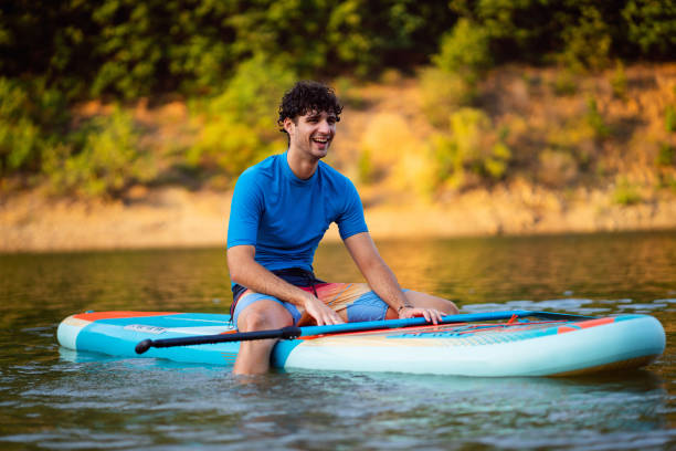 istock Caucasian man, sitting on a standup paddleboard and enjoy the view 1420125003