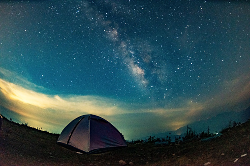 Camping tent on the top of the mountain and starry milky way