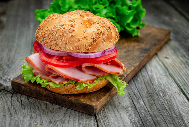istock Sandwich with ham and vegetables on an old wooden table 1420126965