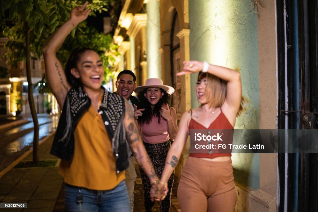 Lesbian couple having fun with their friends in the city at night 30-39 Years Stock Photo