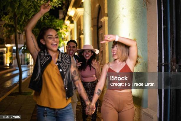 Lesbian Couple Having Fun With Their Friends In The City At Night Stock Photo - Download Image Now