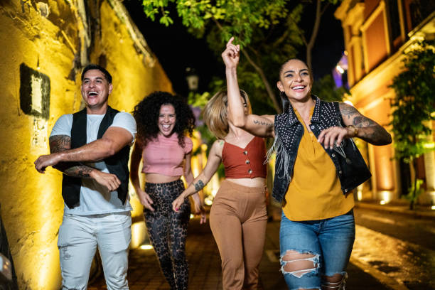 istock Friends walking and having fun in the city at night 1420130162