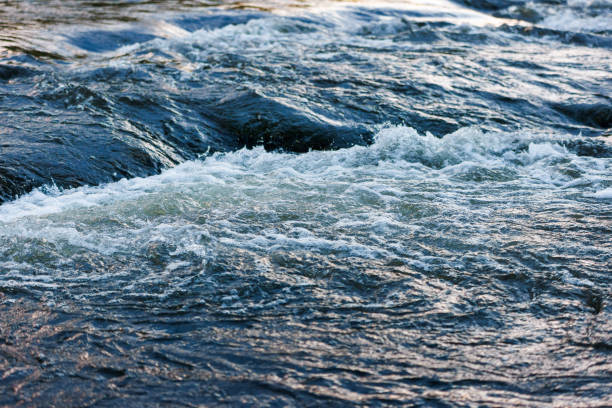 istock flowing water of a summer river with a small rapid waterfall at evening light 1420130626