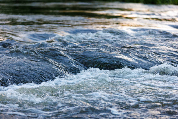 istock flowing water of a summer river with a small rapid waterfall at evening light 1420130627