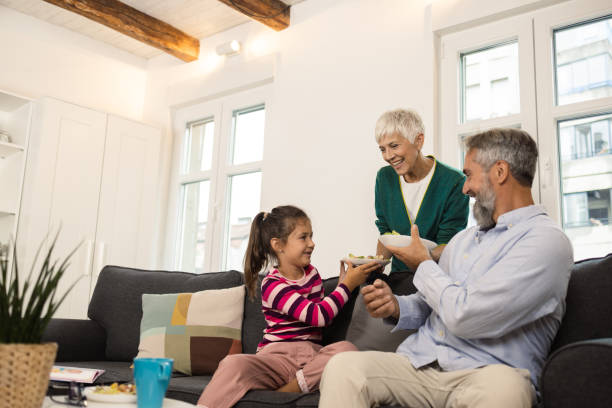 istock Grandparents enjoying dinner with their cute granddaughter 1420132614