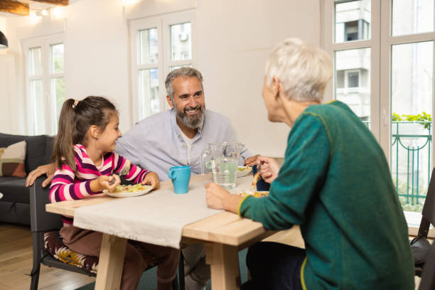 istock Girl and her grandparents dining together 1420132639