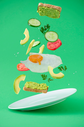 Healthy avocado sandwich on a green background