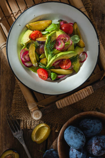 istock Fresh healthy salad with plums and avocado 1420135137