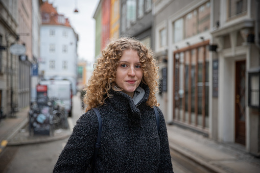 Portrait of a young scandinavian girl in the city center during a winter day