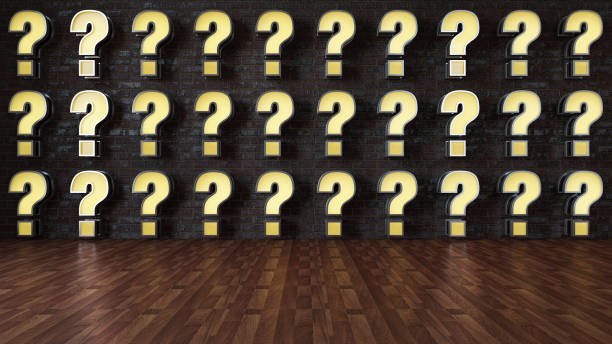 istock Neon Question Mark Signs on Black Brick Wall 1420139528