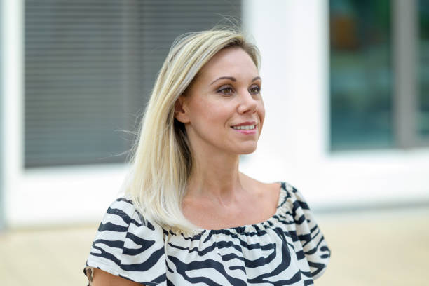istock Attractive middle aged woman looking back over her shoulder 1420140011