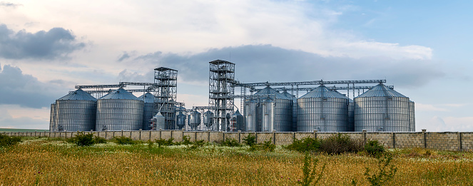 Agricultural field with silo grains in the background