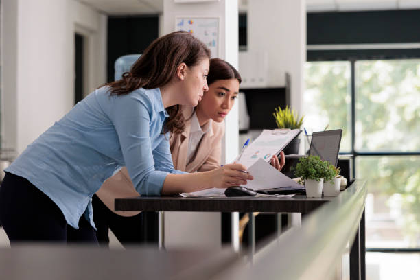 istock Start up company employees discussing financial report 1420144854