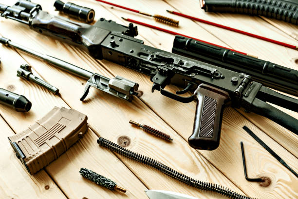 istock Disassembled rifle with cleaning tools on table of weapons workshop 1420145541