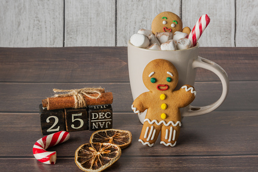 Christmas composition of gingerbread man, coffee, sweets and calendar. New Year and Christmas concept.
