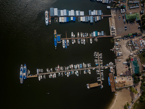 Aerial view of yacht club and marina. Colorful boats and yachts. Top view from drone of harbor with yacht, motorboat and sailboat. Transportation and travel background