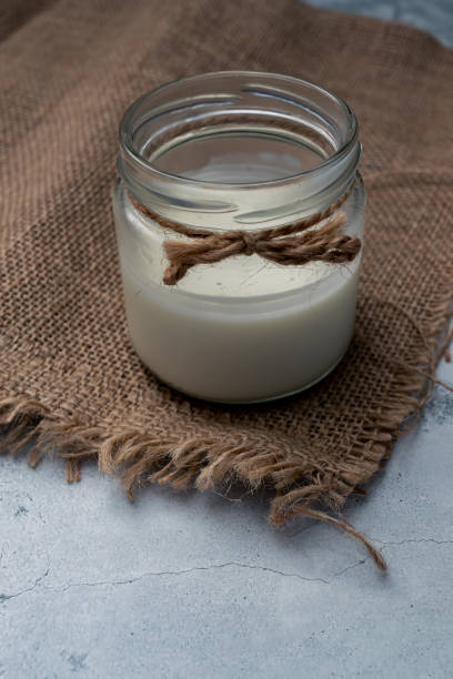 istock Glass jar with milk. World Vegetarian Day. Zero lactose, reusable package. Non-allergic nutrition. Homemade food. Soft focus. 1420152876