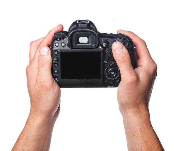 istock Photo camera in hand isolated on white background 1420153538