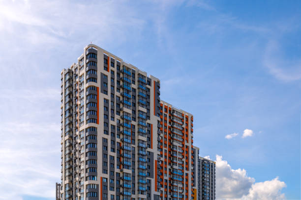 istock freshly built high rise apartment building on blue sky background with thin feathery clouds 1420153670