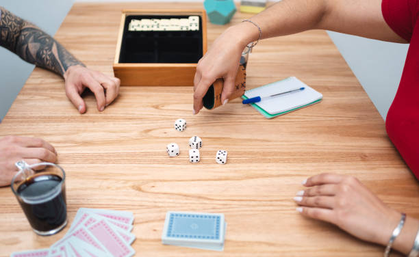 istock Woman rolling dices while playing at home with partner. Close up caption 1420153674
