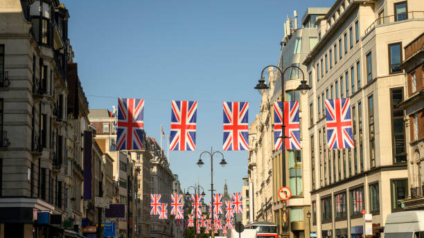 istock Vertical display of Union Jack flags hanging over The Strand 1420154162