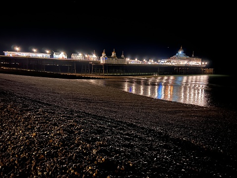 Eastbourne Pier view from along the beach at night.