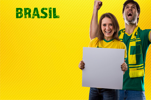 Brazilian Fans, couple Celebrating on a yellow background.