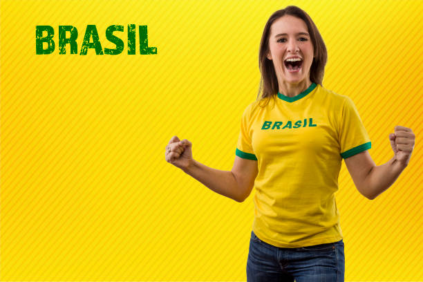 brazilian fan, woman celebrating on a yellow background.