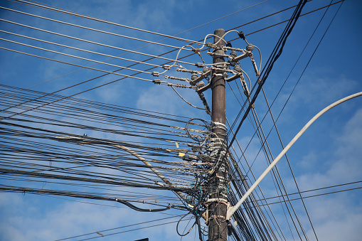 salvador, bahia, brazil - august, 25, 2022: Electric network wiring and TV network cables on a pole of the electric network in the city of Salvador.