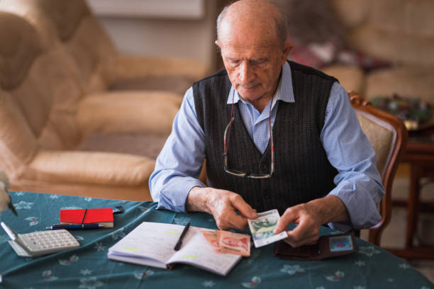 istock Senior man counting Serbian dinars at home 1420162123